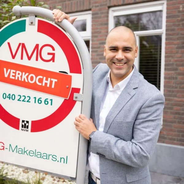 Glimlachende man bij verkocht bord.